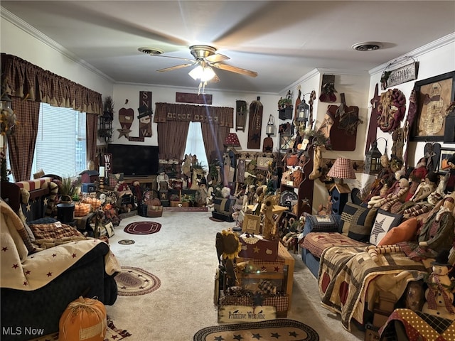 living room featuring ornamental molding, ceiling fan, and carpet