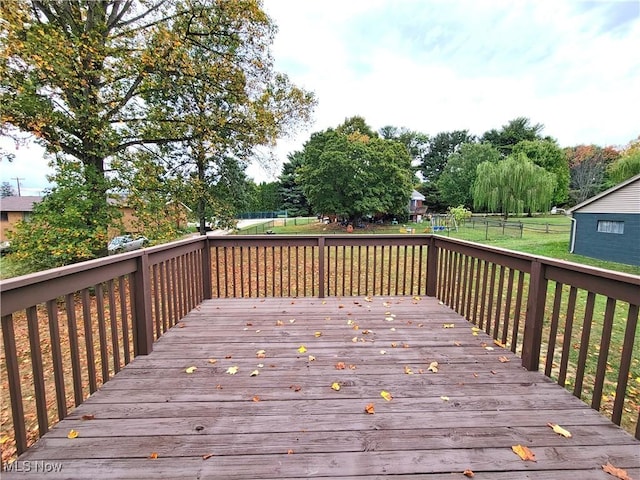 wooden deck featuring a yard