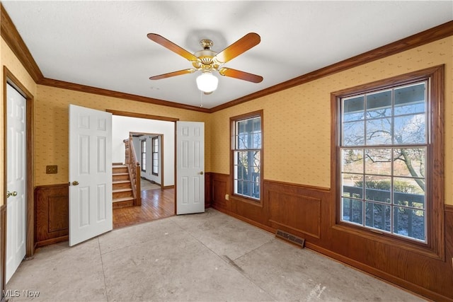 34210 Beacon Dr, Willoughby, OH 44094 - interior space with multiple windows, crown molding, and ceiling fan