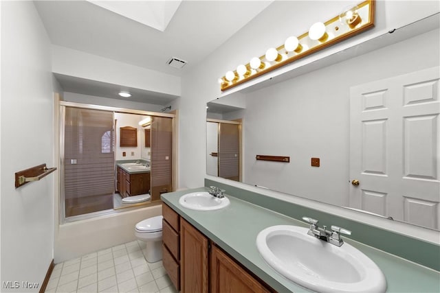 34210 Beacon Dr, Willoughby, OH 44094 - full bathroom with tile patterned floors, toilet, bath / shower combo with glass door, a skylight, and vanity