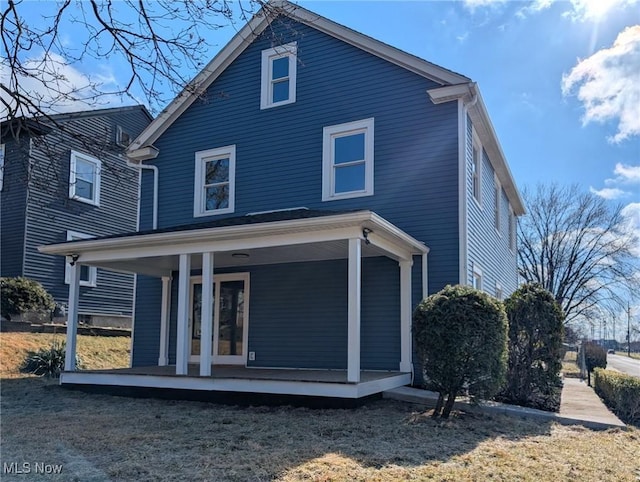 back of property featuring a porch