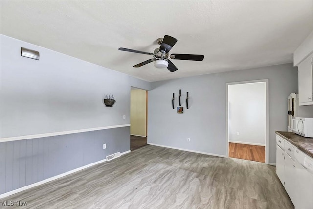 interior space with ceiling fan and light hardwood / wood-style floors