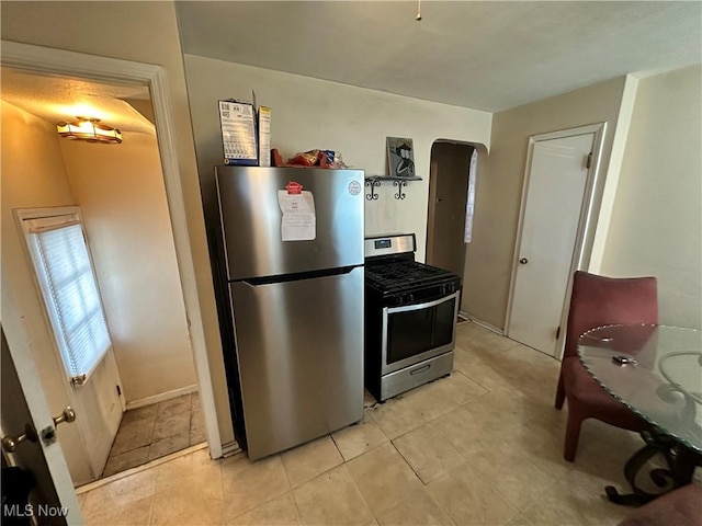 kitchen featuring appliances with stainless steel finishes and light tile patterned floors