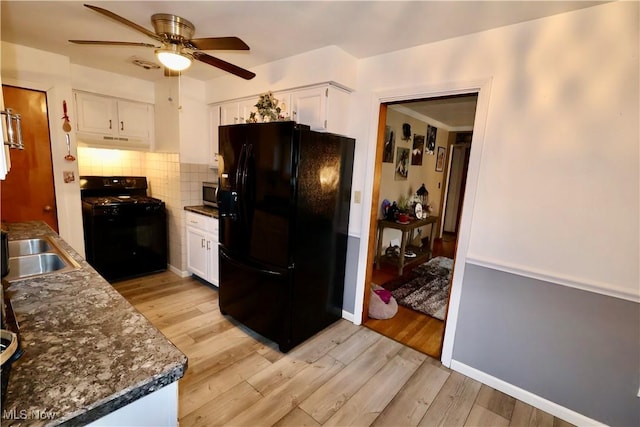 kitchen with sink, white cabinets, backsplash, black appliances, and light wood-type flooring