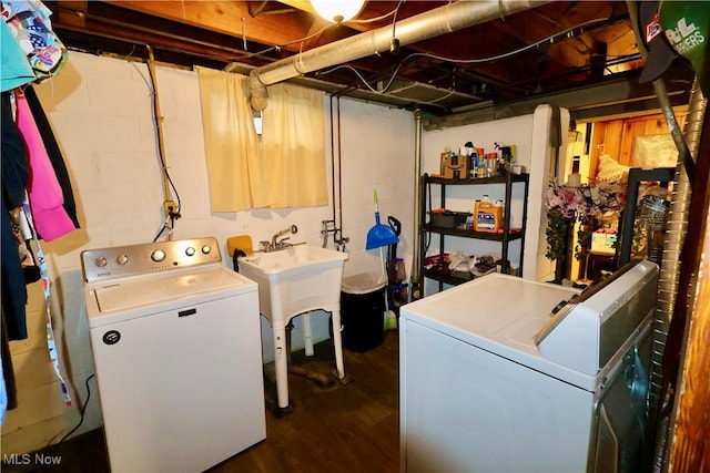 washroom with separate washer and dryer, dark hardwood / wood-style floors, and sink