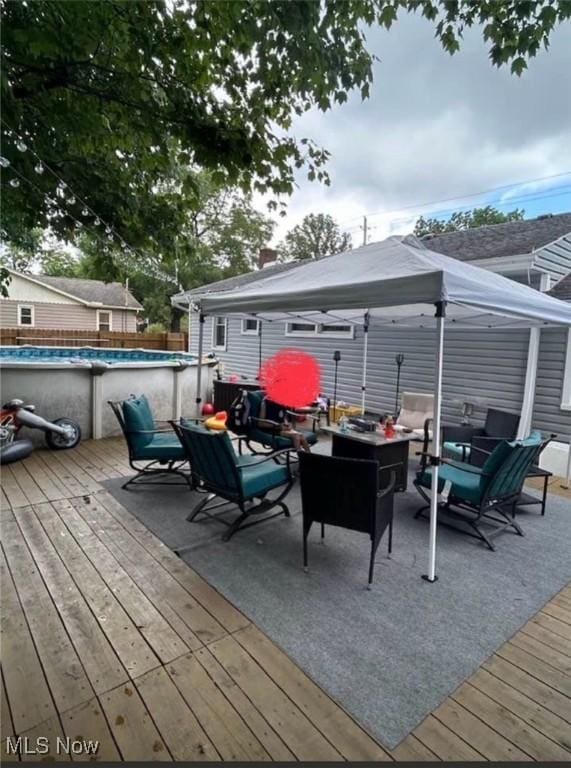 wooden deck featuring a gazebo and an outdoor hangout area