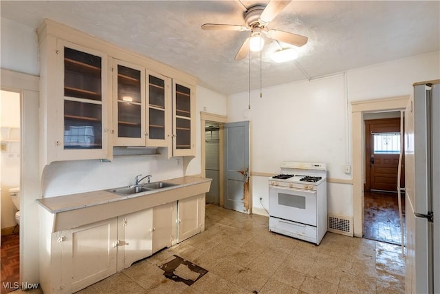 kitchen with ceiling fan, white appliances, and sink