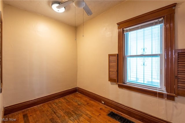 empty room featuring ceiling fan and hardwood / wood-style floors