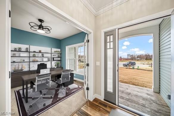 entryway featuring hardwood / wood-style floors and crown molding