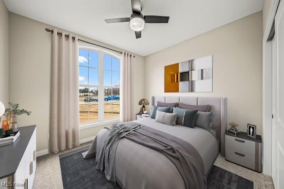 carpeted bedroom with a closet and ceiling fan