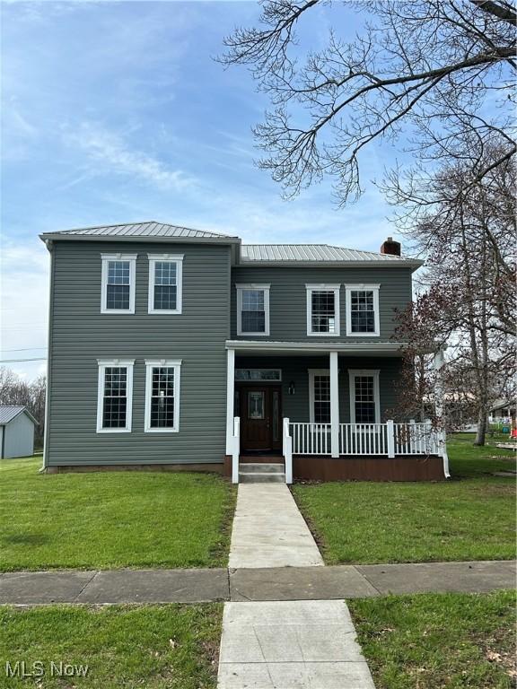 10545 Main St, Norwich, OH 43767 - view of front of home with covered porch and a front lawn