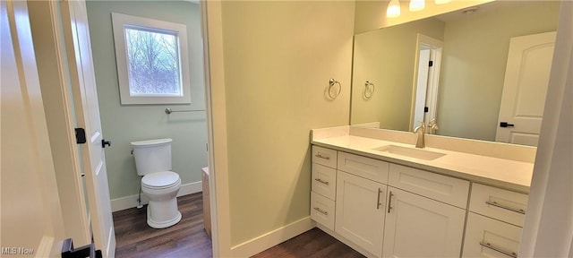 bathroom featuring vanity, toilet, and hardwood / wood-style floors