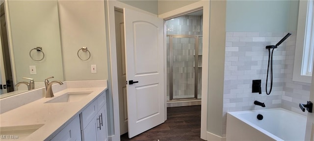 bathroom featuring vanity, hardwood / wood-style flooring, and plus walk in shower