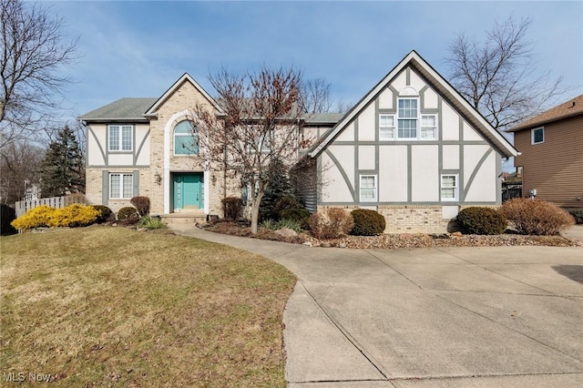 tudor house featuring a front yard