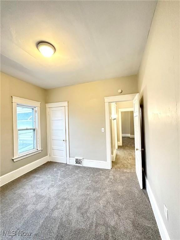 unfurnished bedroom with a closet and carpet flooring