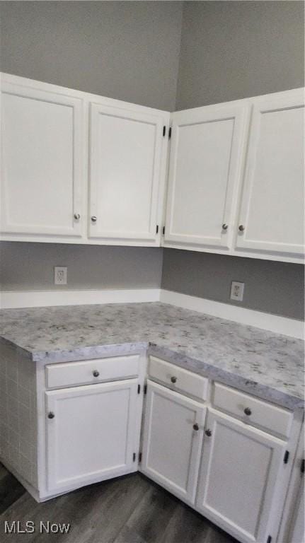 kitchen with white cabinetry and dark wood-type flooring