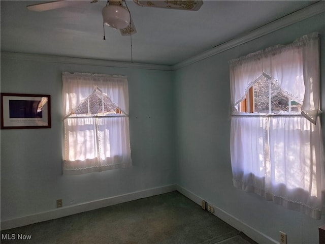 carpeted empty room with crown molding, a wealth of natural light, and ceiling fan