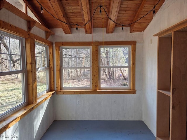 unfurnished sunroom with vaulted ceiling with beams and wooden ceiling