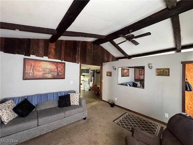 living room featuring vaulted ceiling with beams, ceiling fan, and carpet flooring