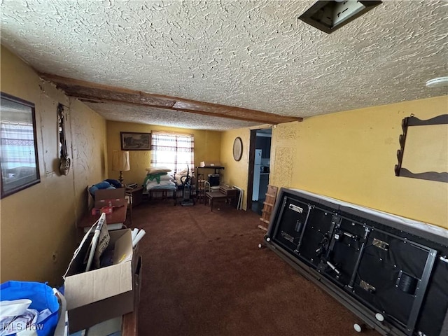 hallway with dark colored carpet and a textured ceiling