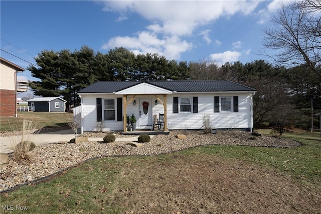 view of front of house with a front yard and covered porch