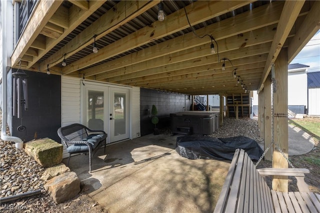 view of patio / terrace featuring french doors and a hot tub