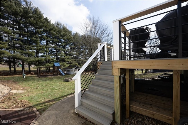 wooden deck featuring a playground and a yard