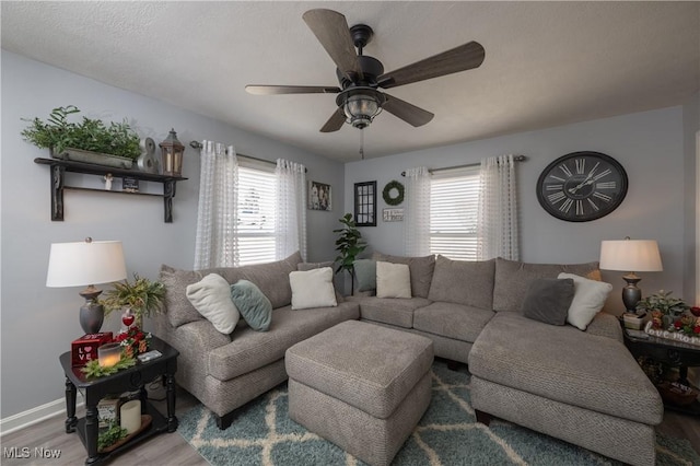 living room featuring ceiling fan, a healthy amount of sunlight, and hardwood / wood-style floors