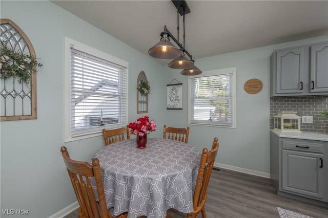 dining space with dark wood-type flooring