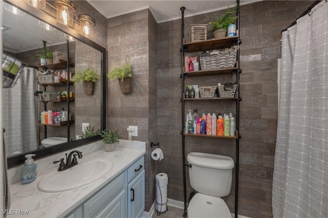 bathroom featuring walk in shower, vanity, and toilet