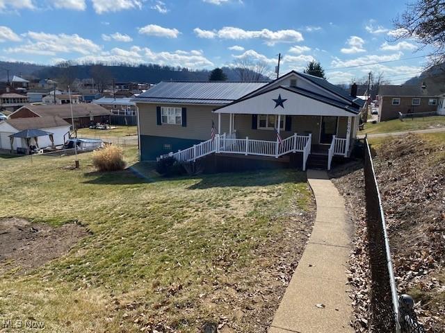 bungalow featuring a porch and a front yard