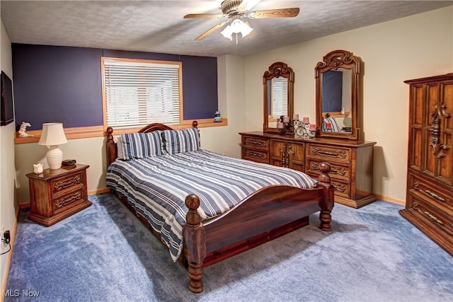 carpeted bedroom featuring ceiling fan and a textured ceiling