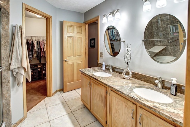 bathroom with vanity, tile patterned flooring, and a shower with shower door