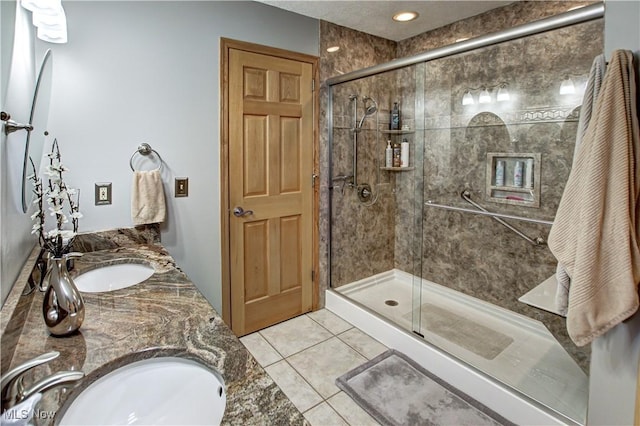 bathroom featuring a shower with door, vanity, and tile patterned flooring