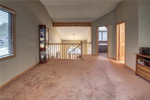 additional living space with vaulted ceiling and carpet flooring