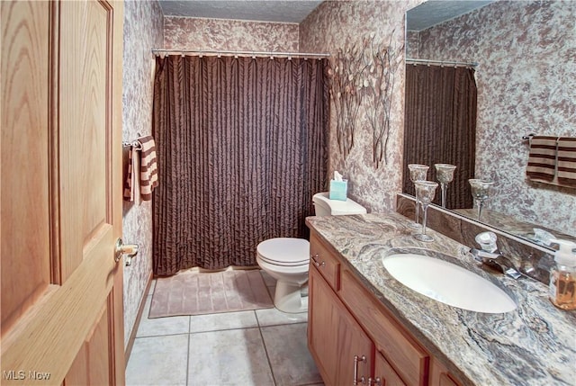 bathroom featuring vanity, toilet, tile patterned floors, a textured ceiling, and a shower with shower curtain