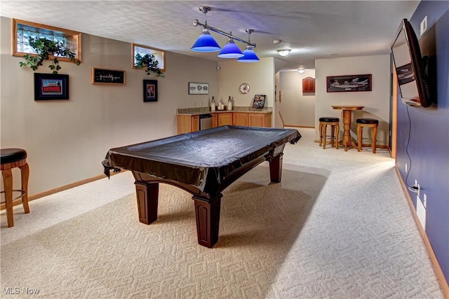 rec room with light colored carpet, bar area, pool table, and a textured ceiling