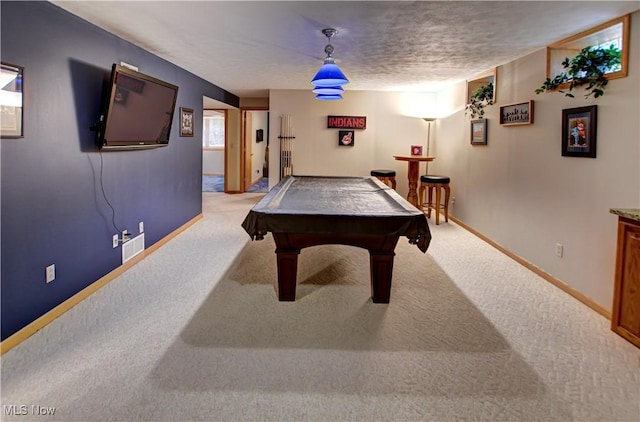 recreation room with light colored carpet, pool table, and a textured ceiling