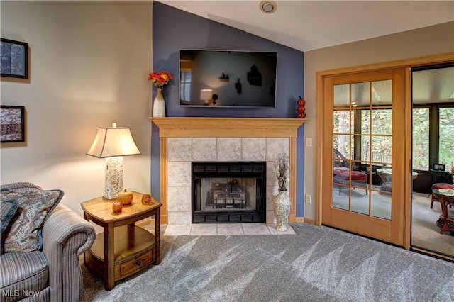 interior space with vaulted ceiling, carpet floors, and a fireplace