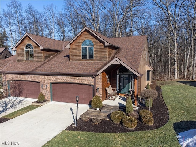 view of front of property with a garage and a front lawn