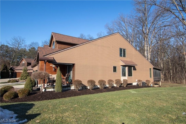 view of side of home featuring a yard