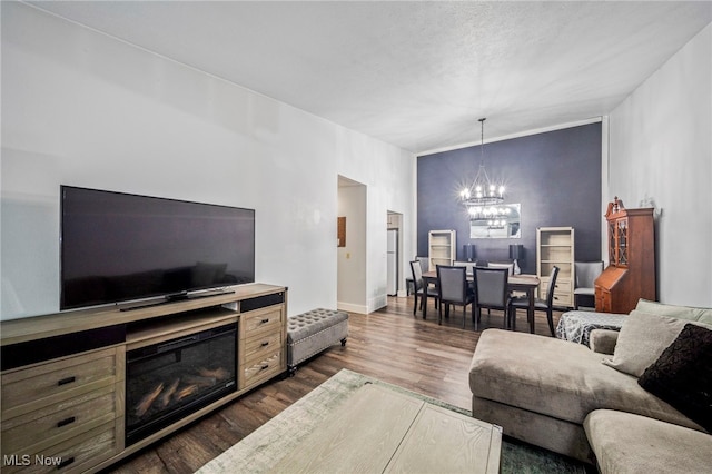 living room with dark hardwood / wood-style flooring and a chandelier