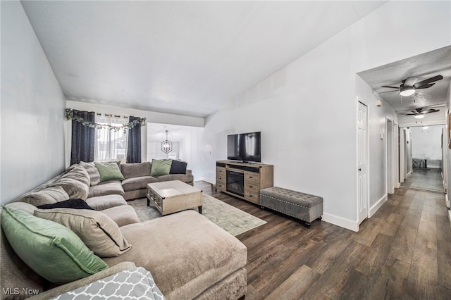 living room featuring vaulted ceiling and dark hardwood / wood-style flooring