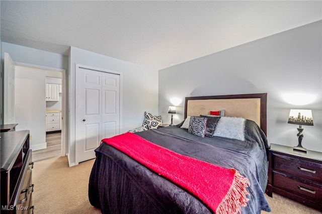 bedroom featuring light carpet and a closet