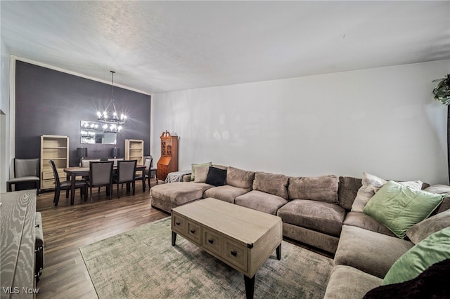 living room featuring wood-type flooring and an inviting chandelier