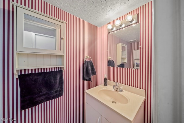 bathroom with vanity and a textured ceiling