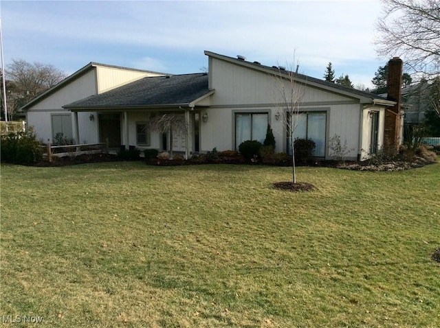 view of side of property with a lawn