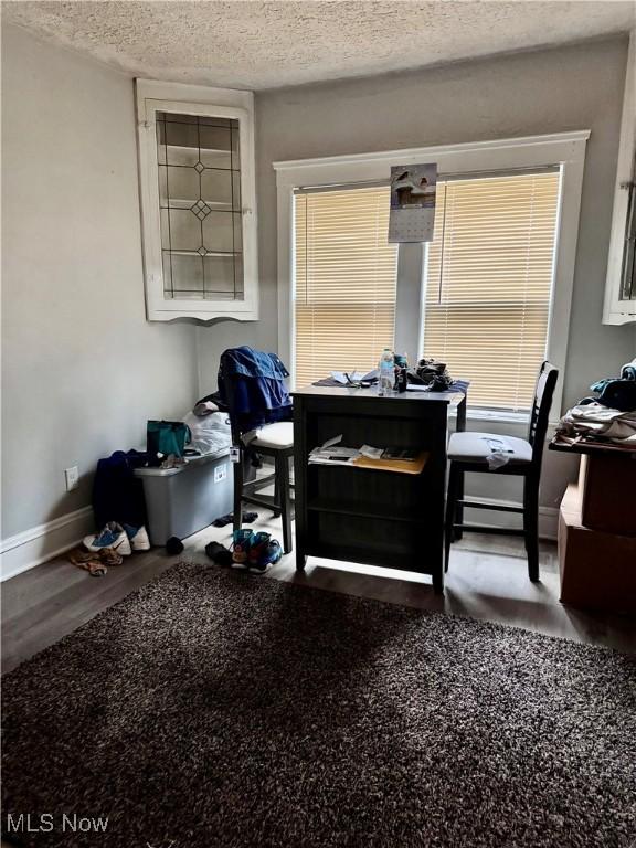 misc room with hardwood / wood-style floors and a textured ceiling