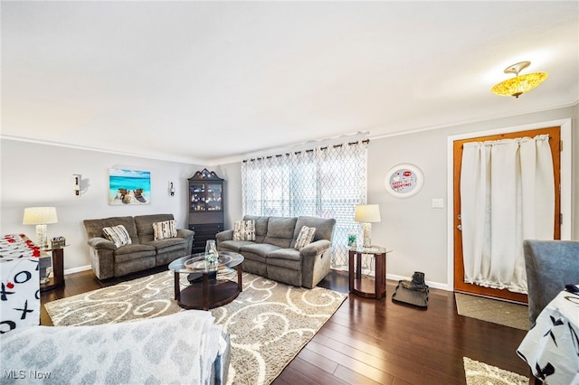 living room featuring dark hardwood / wood-style flooring and crown molding