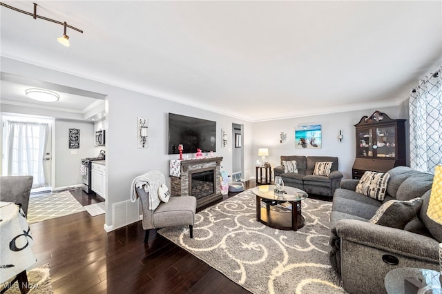 living room with crown molding and dark wood-type flooring